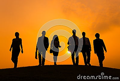 Group of Business People Walking in Back Lit