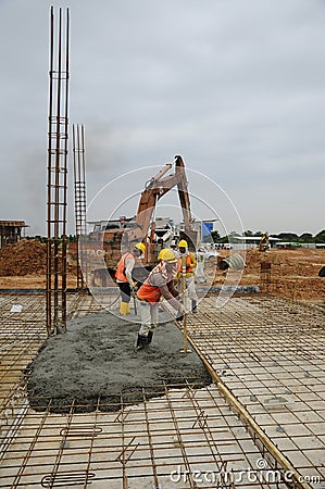 A group of construction workers casting floor slab