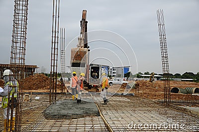 A group of construction workers casting floor slab