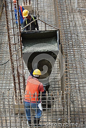 Group of construction workers casting ground floor slab