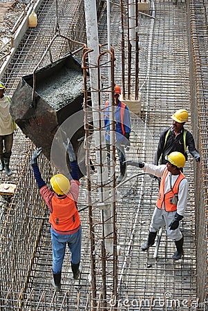 Group of construction workers casting ground floor slab