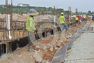 Group of construction workers installing ground beam formwork