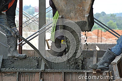 Group of construction workers plastering wall