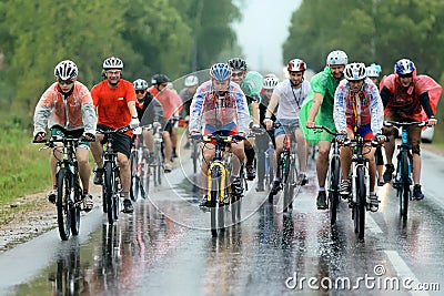 A group of cyclist racer racing in the rain