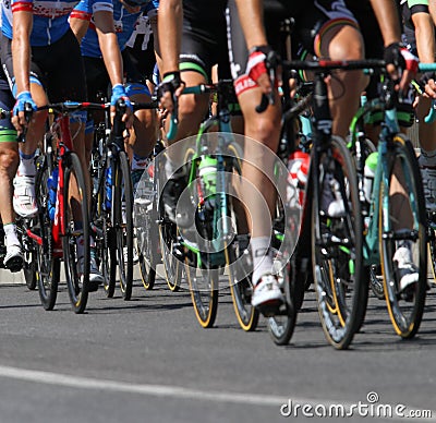Group of cyclists ride uphill vigorously during the cycling race