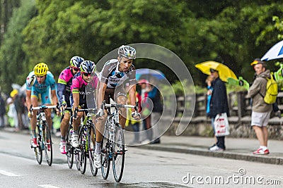 Group of Cyclists Riding in the Rain