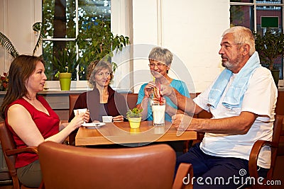 Group drinking coffee in gym