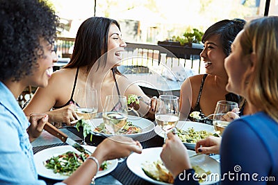 Group Of Female Friends Enjoying Meal At Outdoor Restaurant