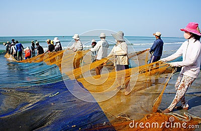 Group of fisherman pull fish net