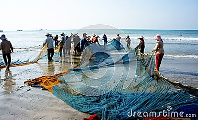 Group of fisherman pull fish net