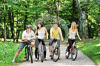 Group of four adults on bicycles in the countryside