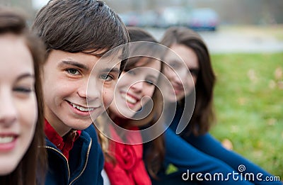 Group of Four happy teenagers outside