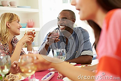 Group Of Friends Sitting Around Table Having Dinner Party