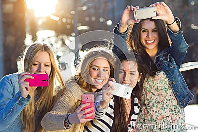 A group of friends taking photos with a smartphone