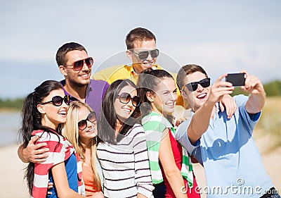 Group of friends taking picture with smartphone