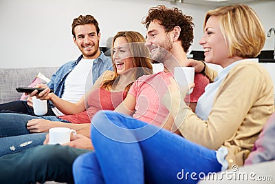 Group Of Friends Watching Television Together At Home