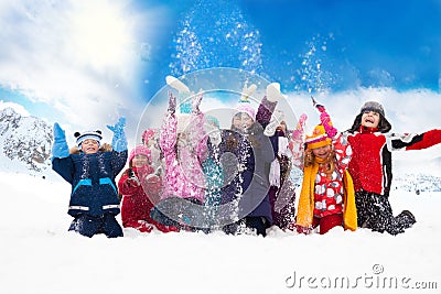 Group of happy kids throwing snow
