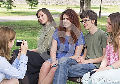 Group of happy young college students taking a photo