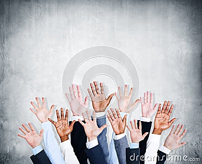 Group of Human Arms Raised with Concrete Wall