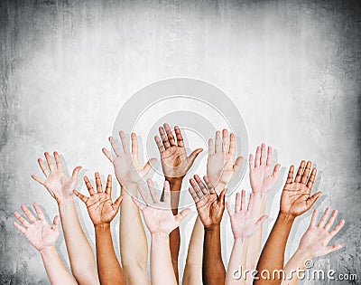 Group of Human Arms Raised with Concrete wall