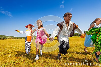 Group of kids running in Halloween costumes