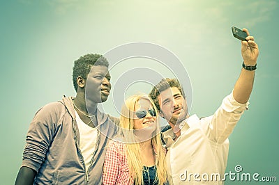 Group of multiracial happy best friends taking a vintage selfie