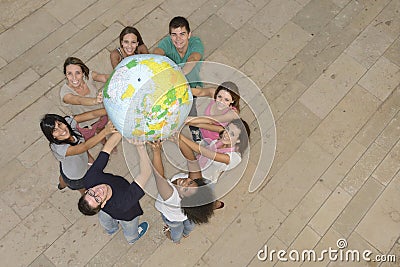Group of people holding the Earth Globe