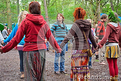 Group of people holding hands in a circle, harmony