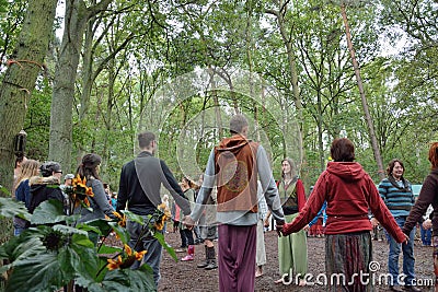 Group of people holding hands in a circle, harmony