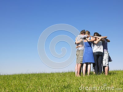 Group of People in Huddle in Field
