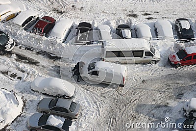 Group of people pushing a car in the snow