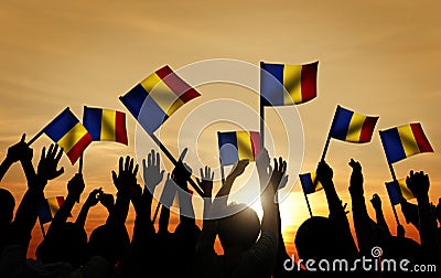 Group of People Waving Romanian Flags in Back Lit