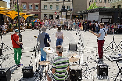 Group perform on street and people listen concert