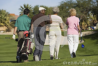 Group of senior golfers walking on golf course
