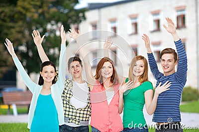 Group of smiling students waving hands