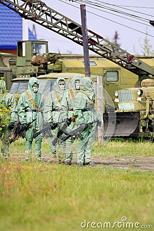 A group of soldiers with guns in their masks and protective clot