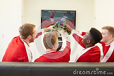 Group Of Sports Fans Watching Game On TV At Home