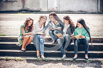 Group of students sitting with a books