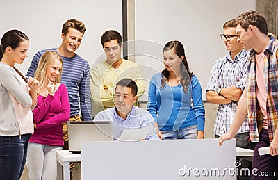 Group of students and teacher with laptop