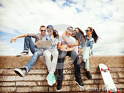 Group of teenagers looking at tablet pc