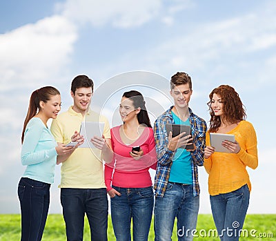 Group of teenagers with smartphones and tablet pc