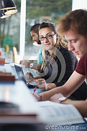 Group of three people in library