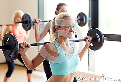 Group of women with barbells in gym