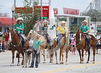 Group of women on horseback for 4H in a parade in small town America