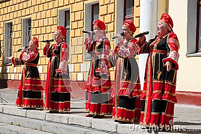 The group of women sing a song, wearing traditional Russian clothes in Moscow. Day of Victory, May 9,2014.