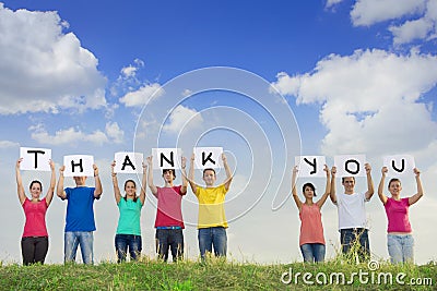 Group of young people spelling thank you