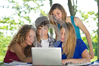 Group of young student using laptop outdoor