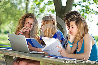 Group of young student using laptop outdoor