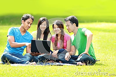 Group of young student using laptop outdoor