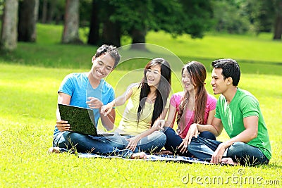 Group of young student using laptop outdoor